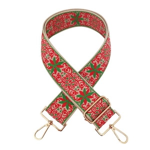 Close-up of ethnic floral embroidery on strap with golden metal lobster clasps