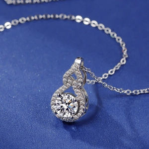 Macro view of a 2-carat zirconia pendant with round center stone and pave setting