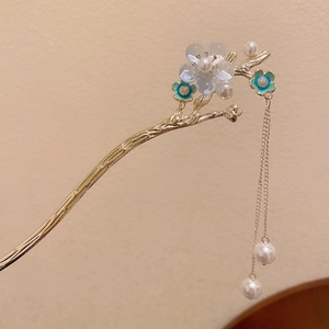 Détail d'une épingle à cheveux fleur dorée avec perles et glands de style chinois