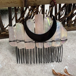 Macro detail of raw crystals and black crescent moon wired on a bohemian hair comb