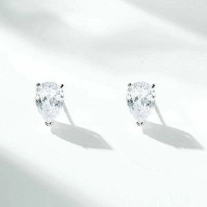 Macro detail of S925 sterling silver pear-cut zircon earrings on white background