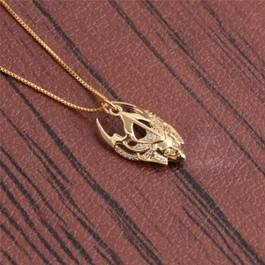 Macro view of a gold-plated fox pendant necklace with sparkling zirconia stones