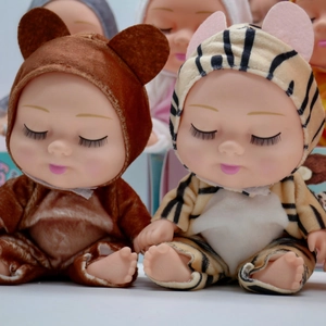 Close-up of sleeping BJD dolls in plush brown bear and yellow tiger outfits