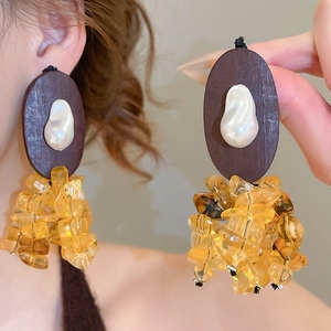 Detail of resin wood drop earrings with baroque pearl and yellow crystal beads
