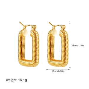 Detail view of gold U-shaped earrings with spiral texture and precise size measurements