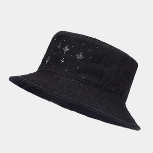 Detail of black denim bucket hat featuring a shimmering rhinestone star pattern on the side