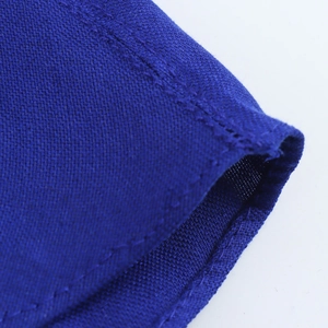 Close-up of blue linen fabric texture with detailed stitching and woven material finish