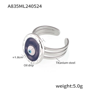 Detail of titanium steel ring with oil-dripped evil eye and triple-layer hollow band