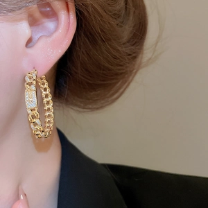Close-up of 18k gold plated chain hoop earrings with micro-pave cubic zirconia stones
