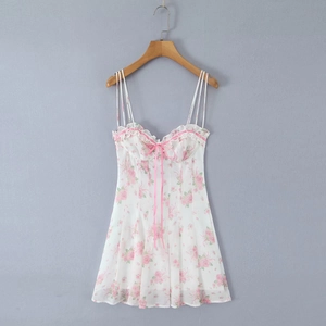 Detail of floral mini dress with pink rose print, ruffled neckline and delicate ribbon bow