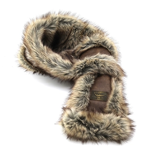 Macro detail of brown faux fur trapper hat lining and premium metallic logo plaque