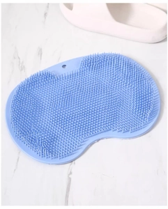 Blue silicone foot massage mat with soft bristles shown on white marble floor