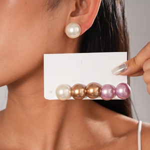 Detail view of 6-piece large faux pearl stud earrings in various elegant metallic colors