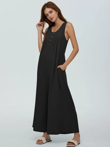 Detail shot of black sleeveless jumpsuit showing vertical ribbed texture and button neckline