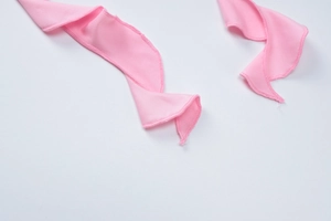 Close-up showing pink fabric texture and high-quality overlock stitching detail