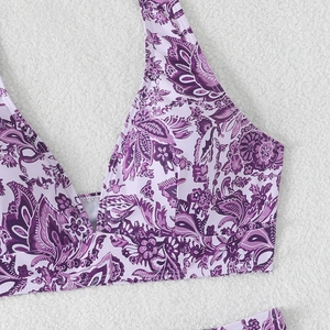 Close-up of purple paisley bikini top fabric with high-quality stitching on white fur