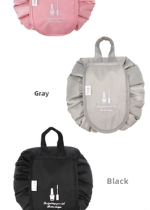 Close-up of three waterproof drawstring cosmetic bags in pink, grey, and black colors