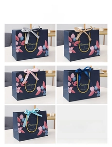 Detail of navy blue floral gift bag with gold Blooming text and colorful ribbon options