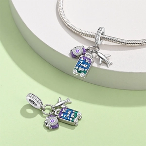 Travel charms set with silver airplane and suitcase featuring Just Go engraving