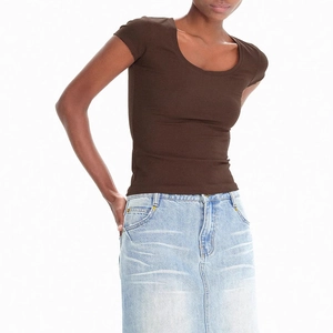 Close-up of slim fit deep brown U-neck T-shirt paired with light blue denim skirt