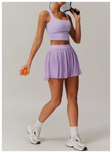 Detail of light purple pleated sports skirt and side-ruched tank top yoga set