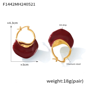 Detailed view of titanium steel earrings with red enamel and golden finish dimensions