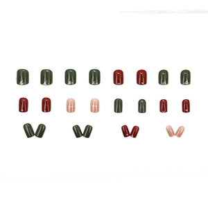 Short press-on nails set in dark green, burgundy red, and pink with glitter details
