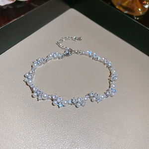 Detailed close-up of zircon winding pearl bracelet with adjustable silver chain
