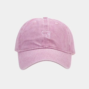 Detailed view of pink washed canvas baseball cap featuring white abstract geometric embroidery