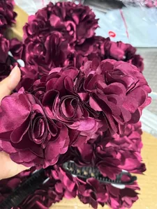 Close-up of a large wine red satin floral banana hair clip with multi-layer petal detail
