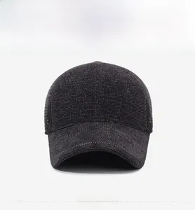 Detailed front view of grey corduroy baseball cap with thermal earmuffs for winter