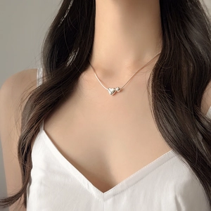 Close-up of S925 sterling silver heart and bead pendant on a sleek snake chain necklace