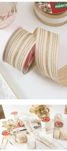 Detail of luxury champagne Merry Christmas ribbon with gold glitter and velvet textures