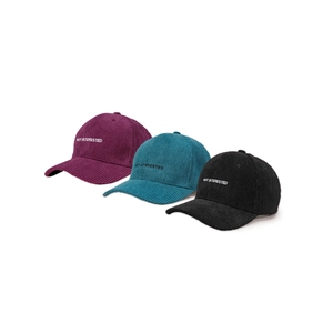 Three corduroy baseball caps in purple, blue, and black with NOT INTERESTED embroidery