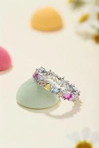 Close-up of S925 silver ring featuring colorful multi-shape zirconia stones on textured stone
