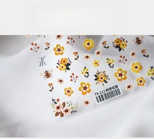 Close-up of 3D embossed floral nail stickers featuring yellow flowers and bees model TS-112