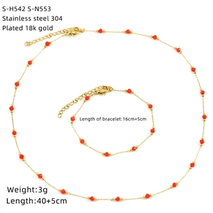 Detailed view of 18K gold plated stainless steel necklace and bracelet set with red beads