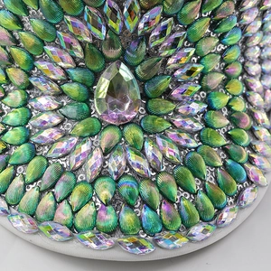 Macro detail of emerald green sequins and sparkling rhinestones on the festive hat rim
