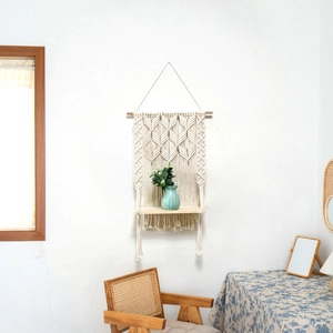 Detailed close-up of a handmade cotton rope macrame wall hanging shelf in boho style