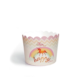 Detail of paper muffin cup featuring colorful wave patterns and a unicorn rainbow design