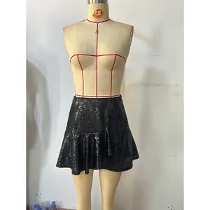 Detailed view of black sequin mini skirt featuring asymmetrical ruffled hem design