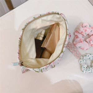 Detail of floral canvas makeup bag with pink flower patterns and inner storage space