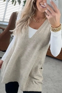 Detail of beige V-neck knitted vest showing textured knit fabric and side pocket design