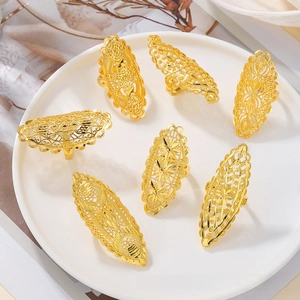 Detailed close-up of seven gold-plated filigree flower rings in Middle Eastern style