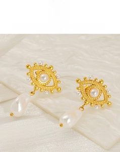 Detail of 18K gold stainless steel evil eye earring with baroque pearl drop
