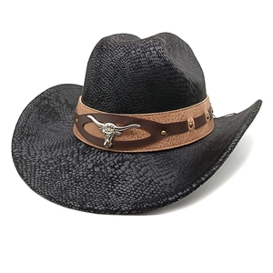 Detail of western cowboy hat featuring black snakeskin texture and silver bull head stud