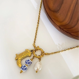 Vintage gold horseshoe necklace with blue floral ceramic beads and baroque pearl pendant