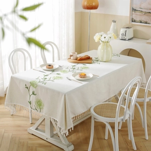 Waterproof linen tablecloth with green floral embroidery and decorative tassel edges