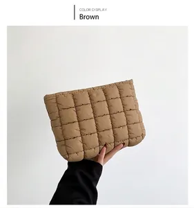 Detail of a brown quilted cotton handbag featuring a classic square padded design