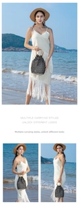 Detail of woven bucket bag featuring natural bamboo handles and black white patchwork